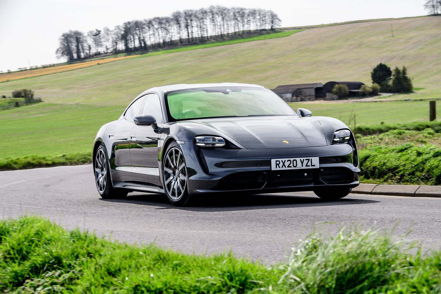 Grey Porsche Taycan turbo driving front