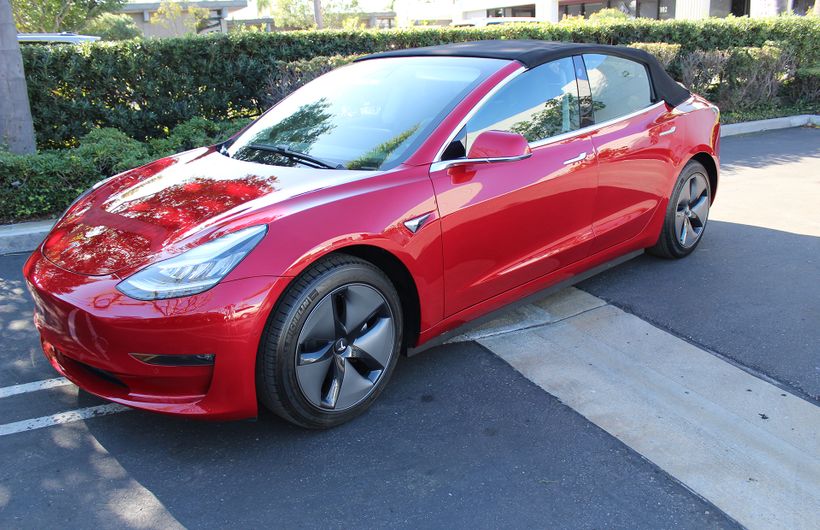 Red Tesla Model 3 convertible front roof up