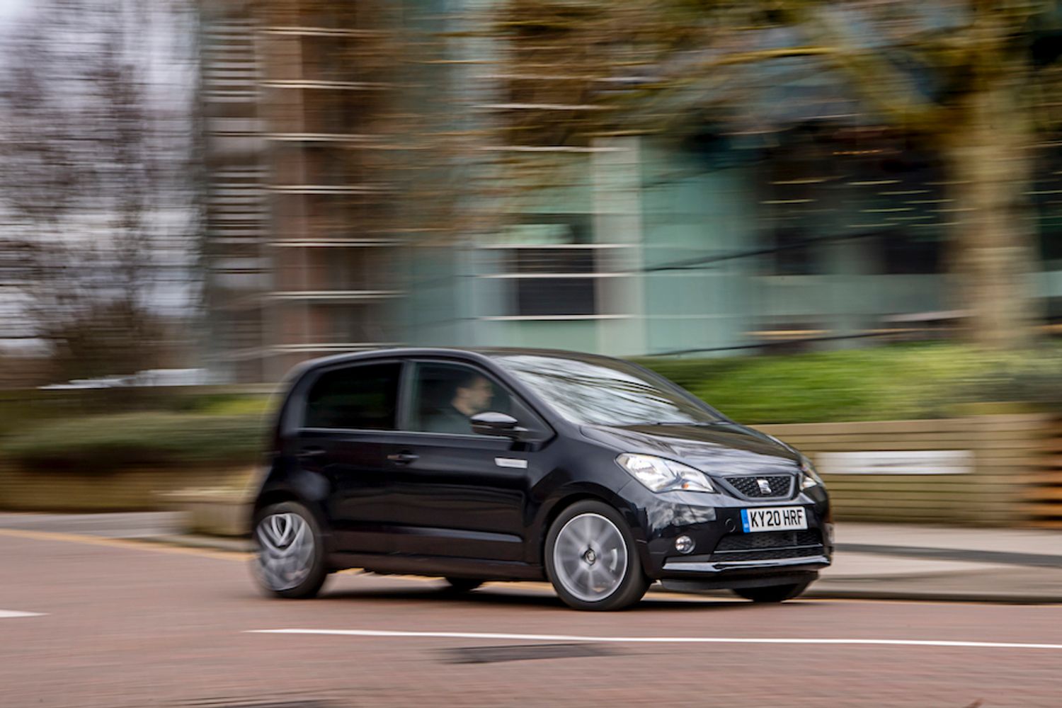 Sear Mii Electric exterior side driving past building