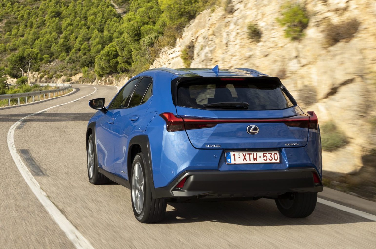 Lexus UX300e exterior rear driving in mountains