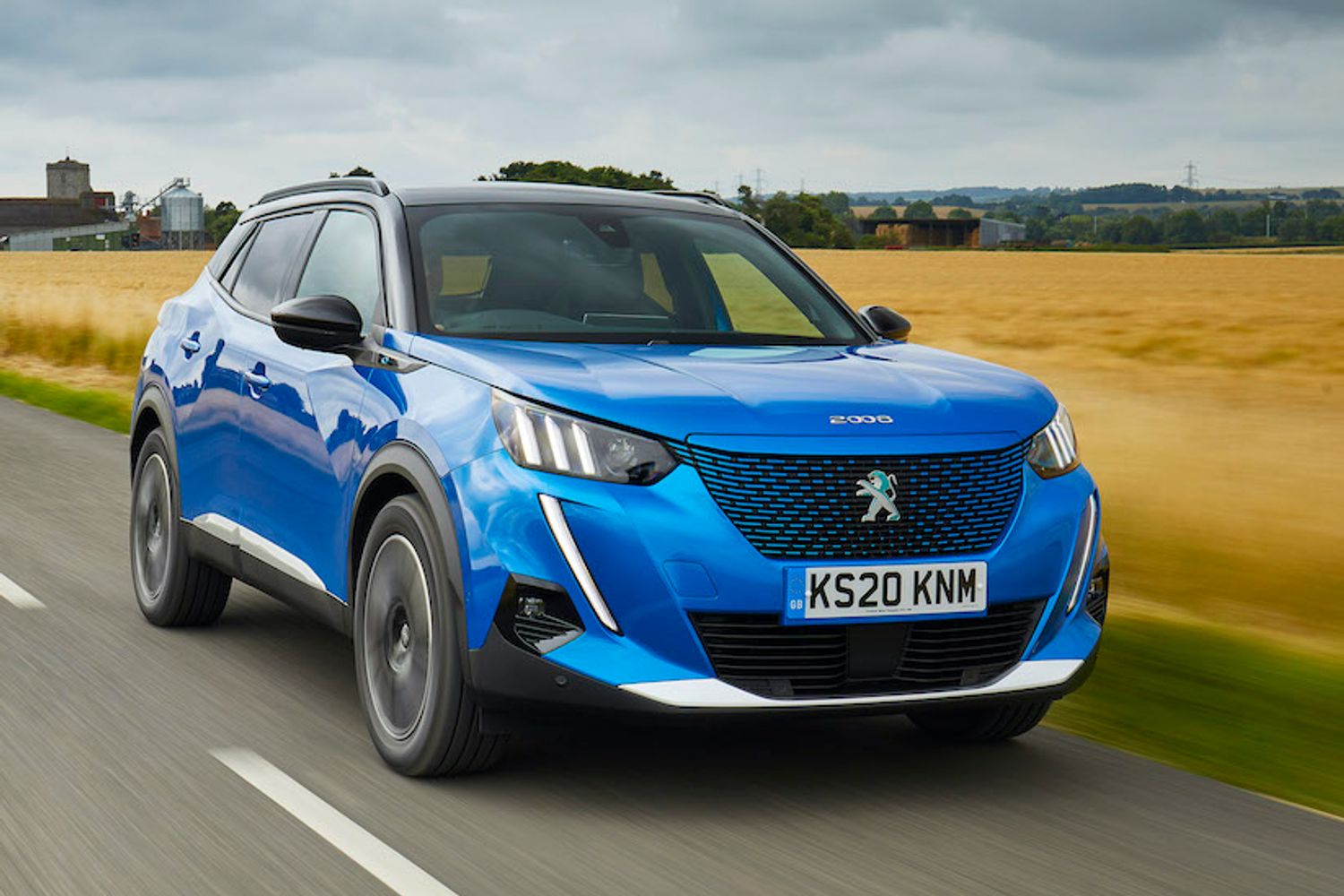 Peugeot E2008 electric car exterior front driving