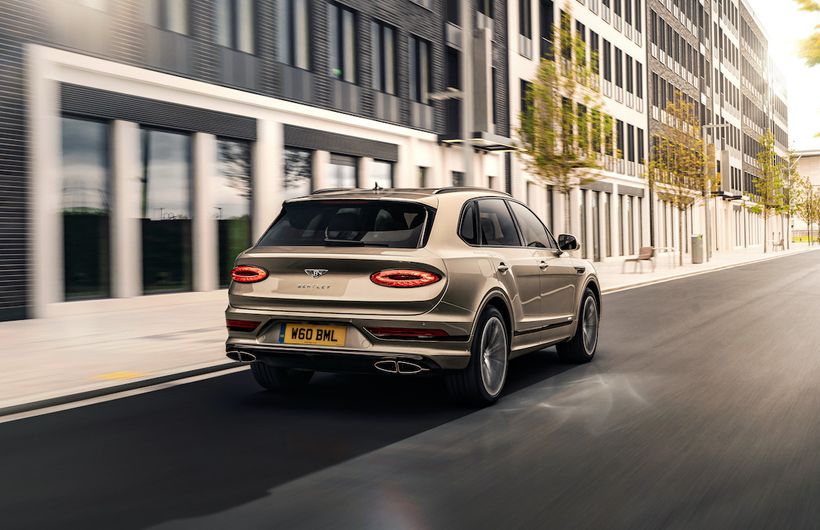 Bentley Bentayga Hybrid exterior rear driving through city  