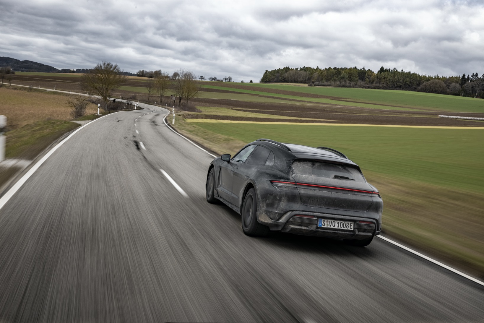 Porsche Taycan Cross Turismo driving in countryside