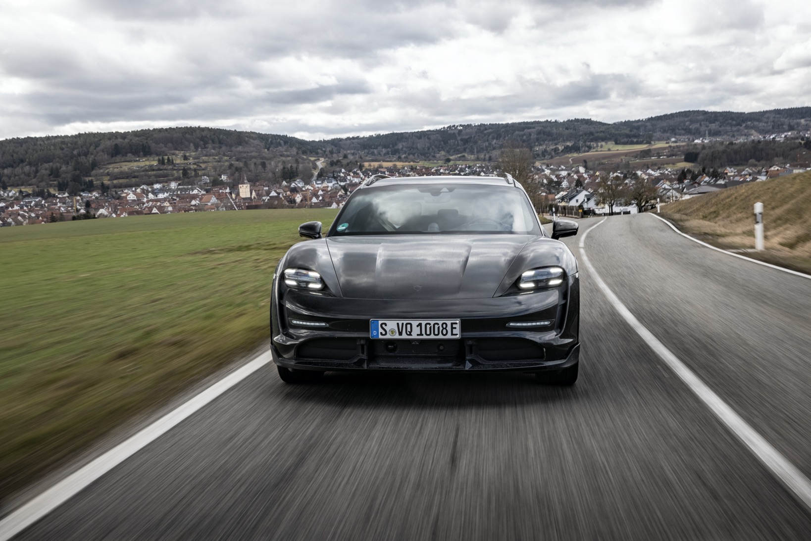 Porsche Taycan Cross Turismo driving in countryside