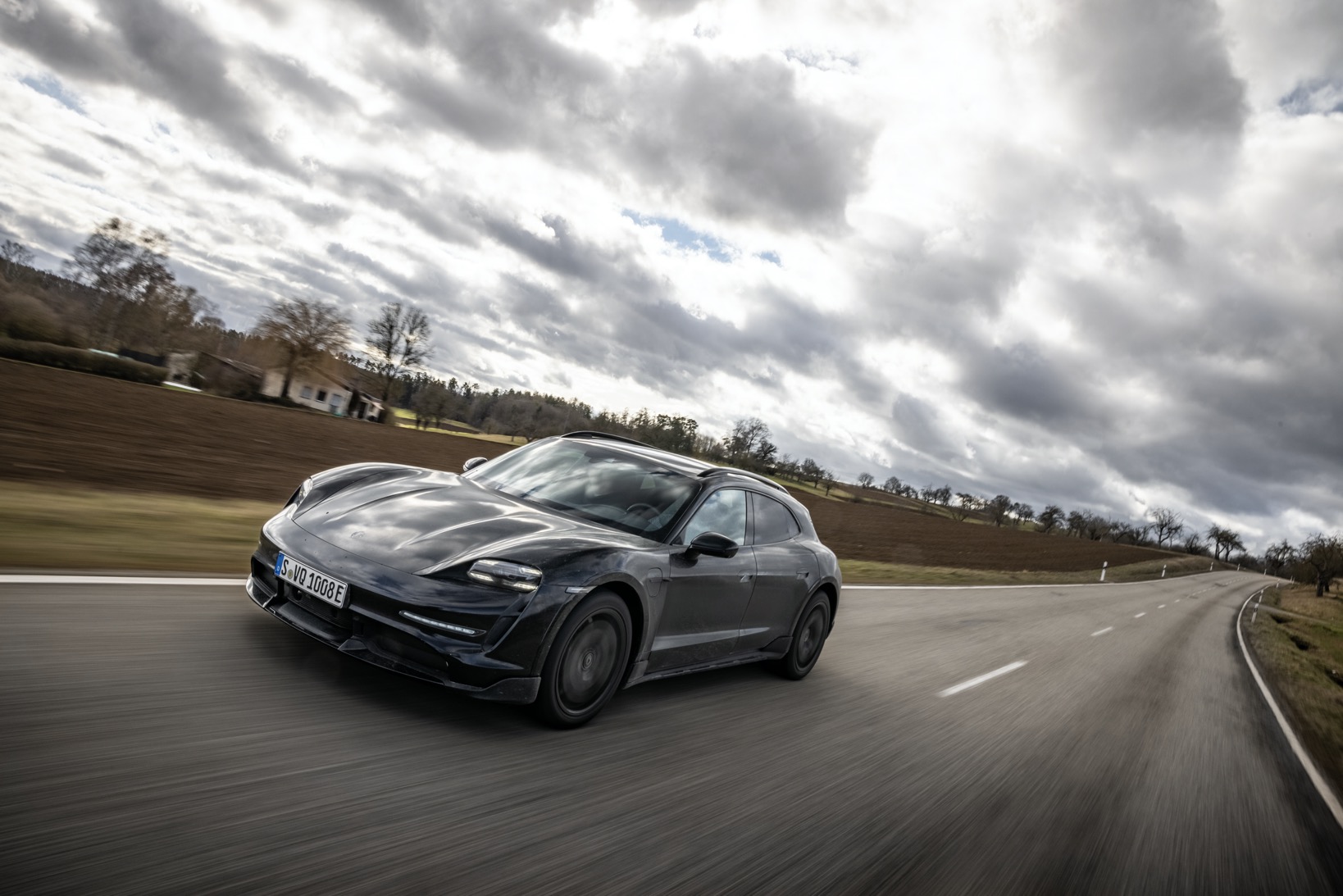 Porsche Taycan Cross Turismo driving in countryside