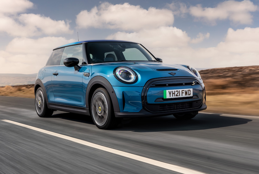 2021 MINI Electric front tracking action shot, blue car, in countryside