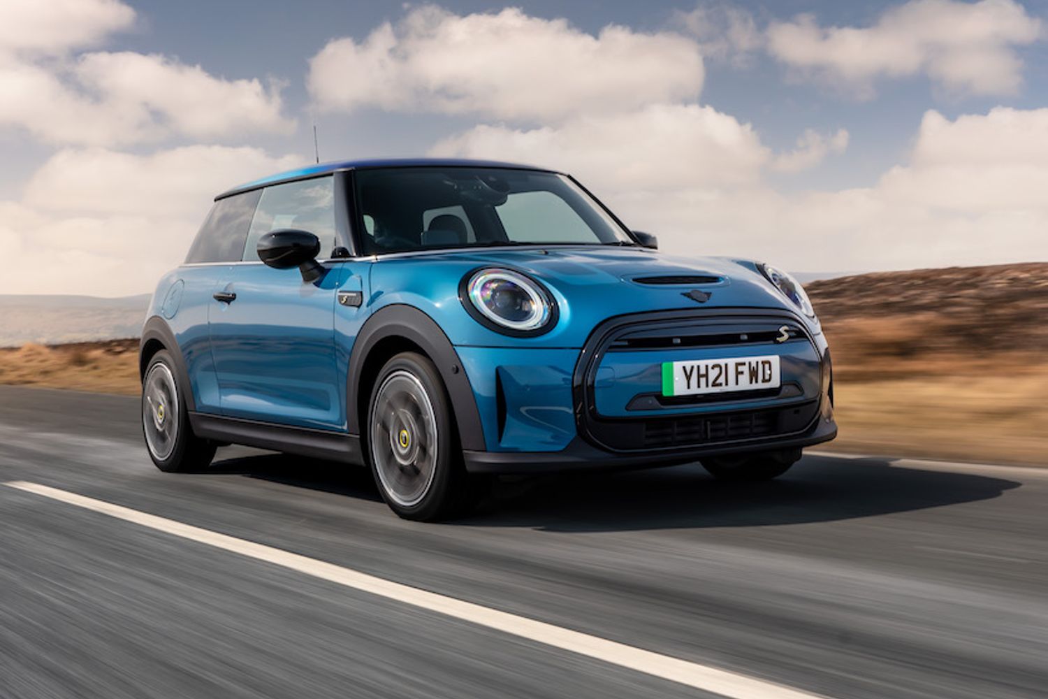 2021 MINI Electric front tracking action shot, blue car, in countryside