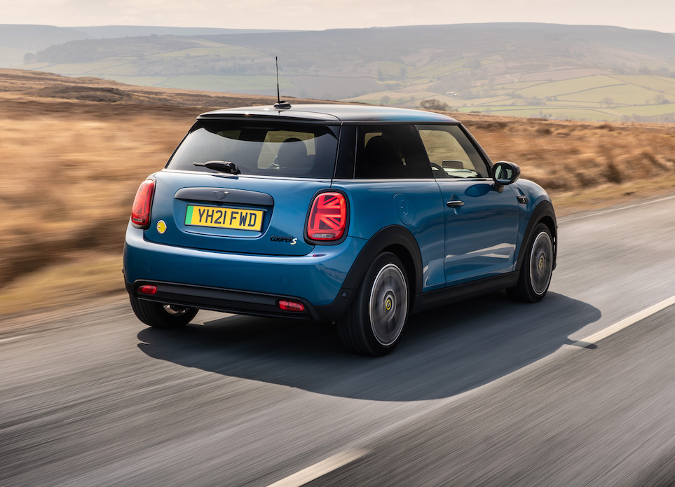 2021 MINI Electric rear tracking action shot, blue car, in countryside