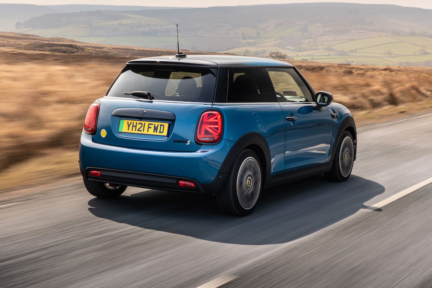 2021 MINI Electric rear tracking action shot, blue car, in countryside