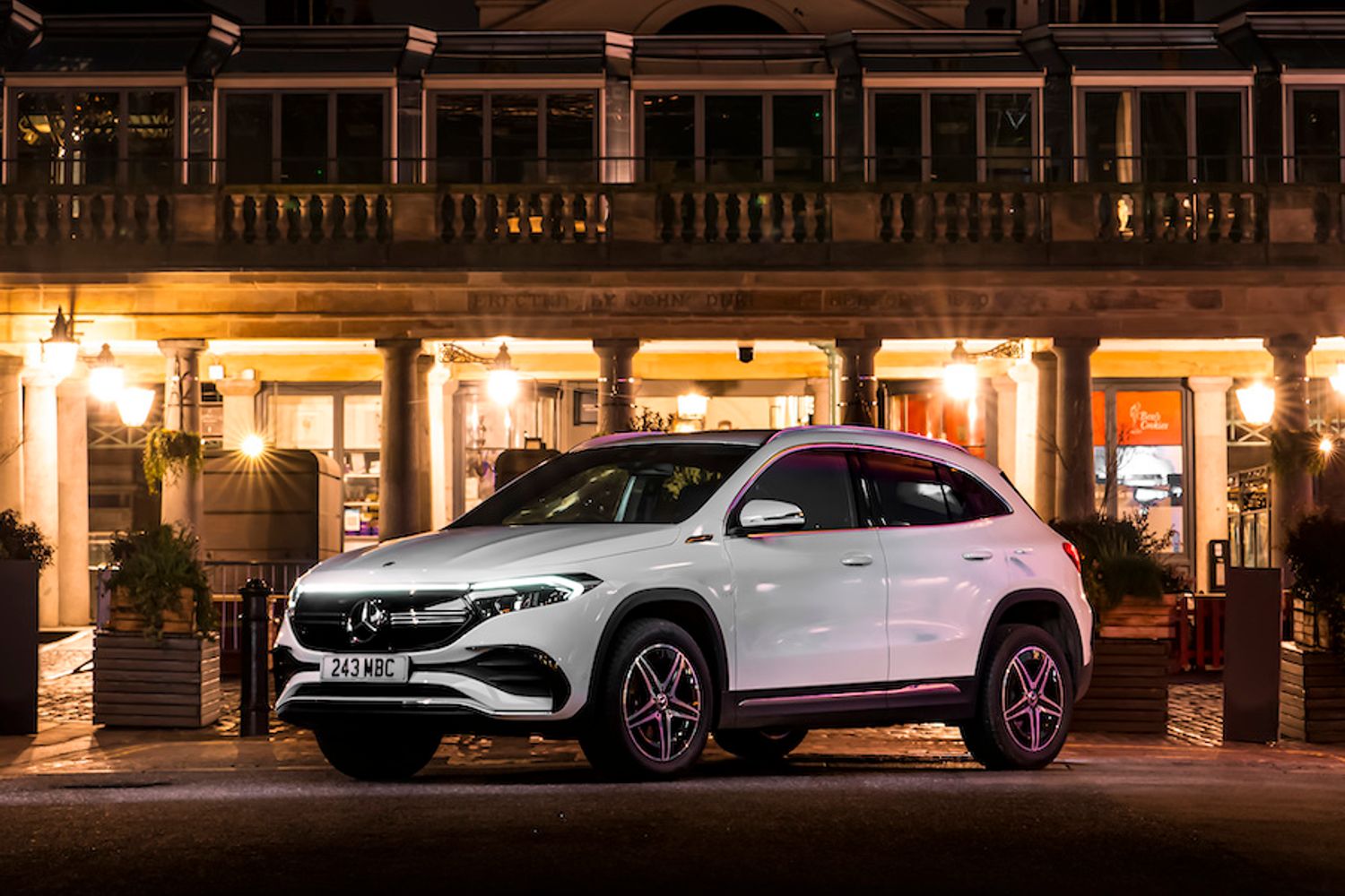 Mercedes EQA static shot, front three quarters, night shot in town