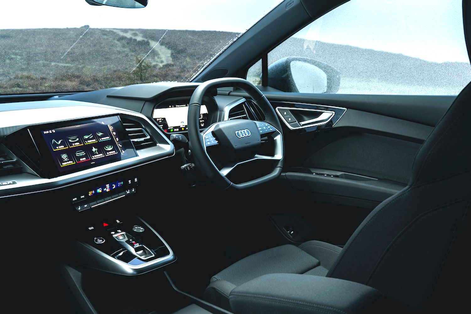 Audi Q4 e-tron interior shot, dashboard and steering wheel, RHD