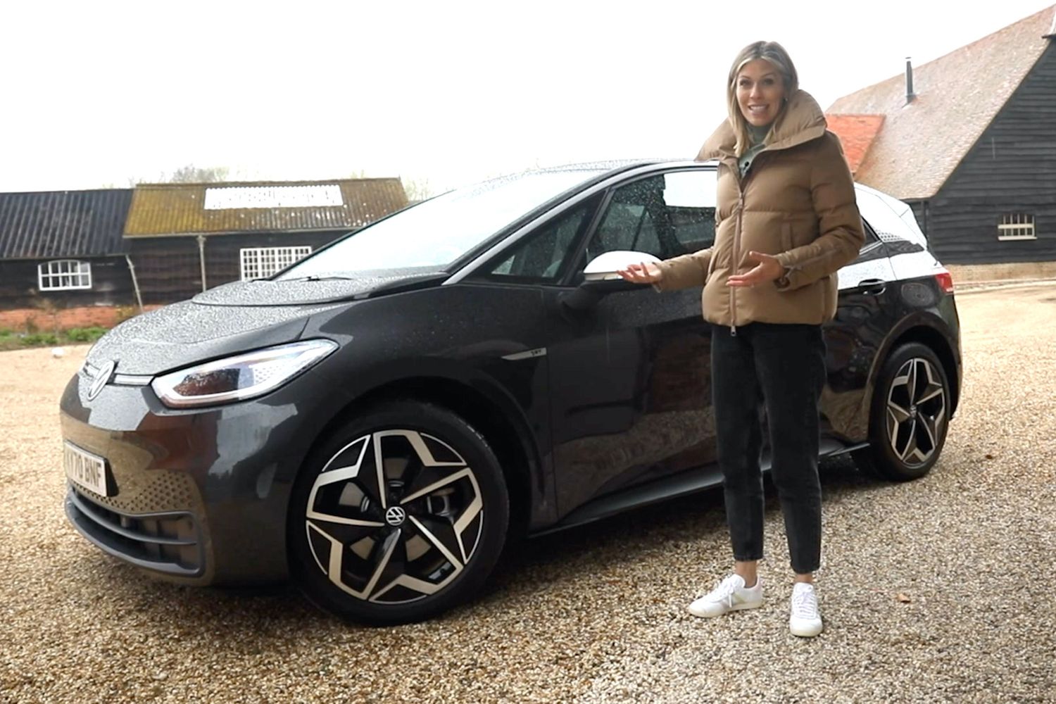 VW ID.3 static shot, black car in a quartyard with presenter Nicki Shields