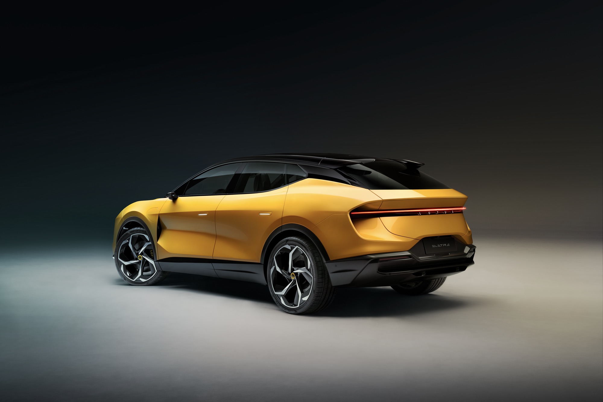 Lotus Eletre rear three quarters, studio, yellow car