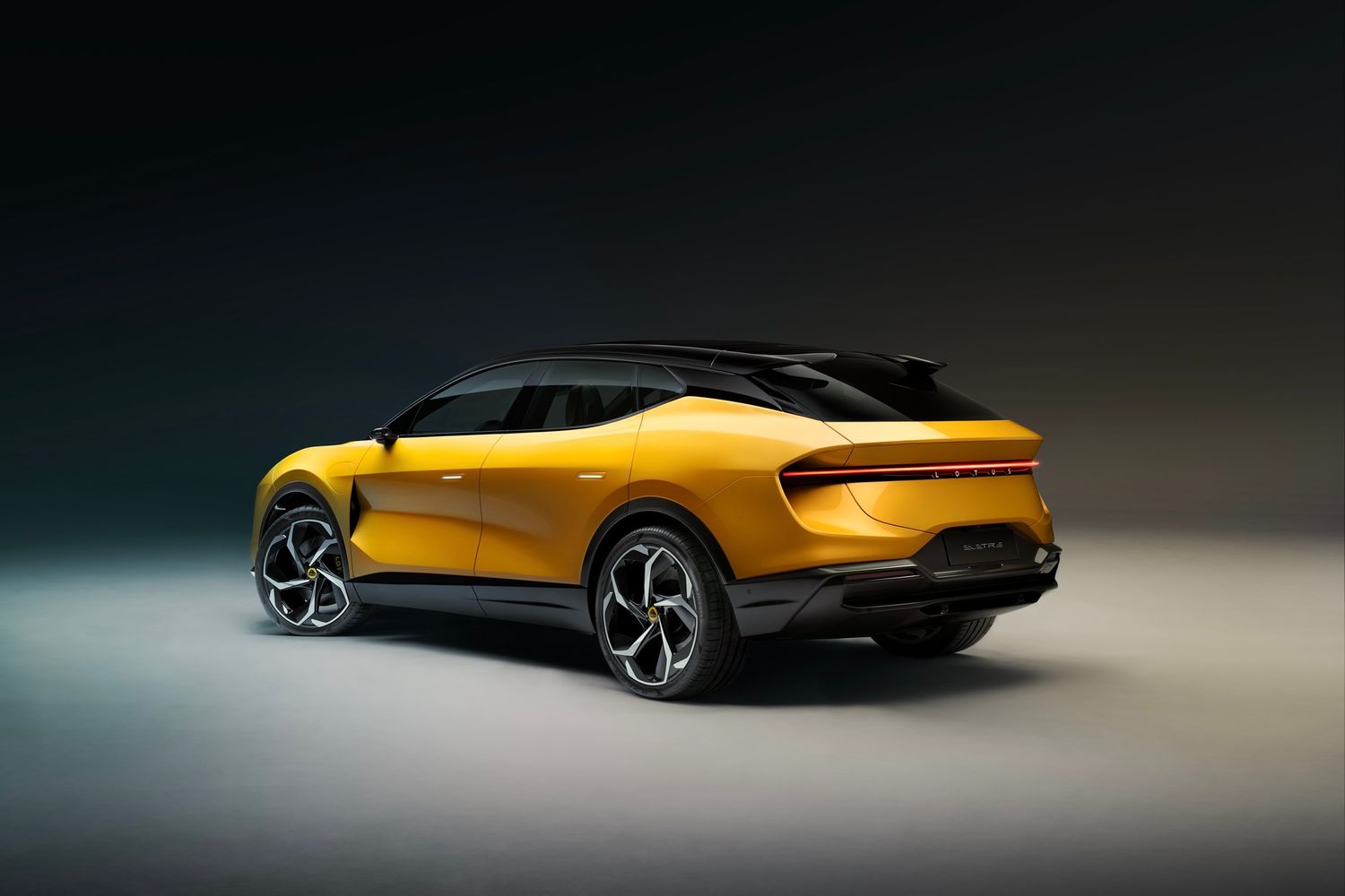 Lotus Eletre rear three quarters, studio, yellow car
