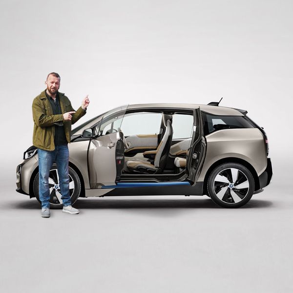 Tom Wookie Ford pointing at a gold BMW i3