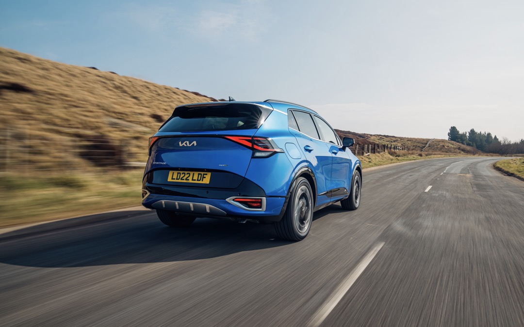 Kia Sportage PHEV, blue, action rear three quarters, RHD, UK registration
