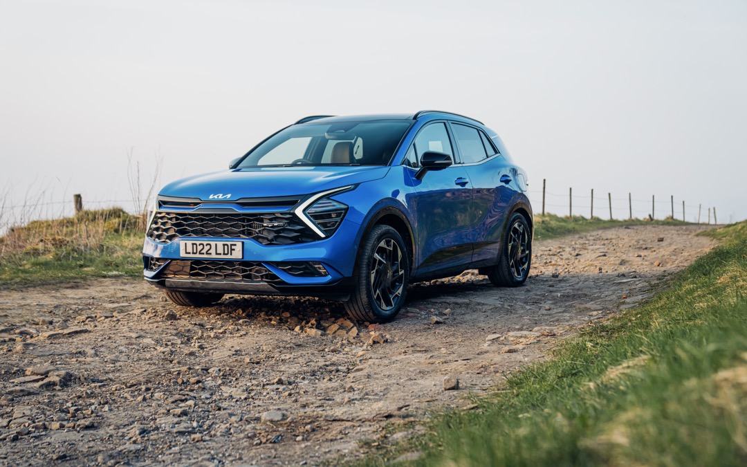 Kia Sportage PHEV, blue, static front three quarters, RHD, UK registration